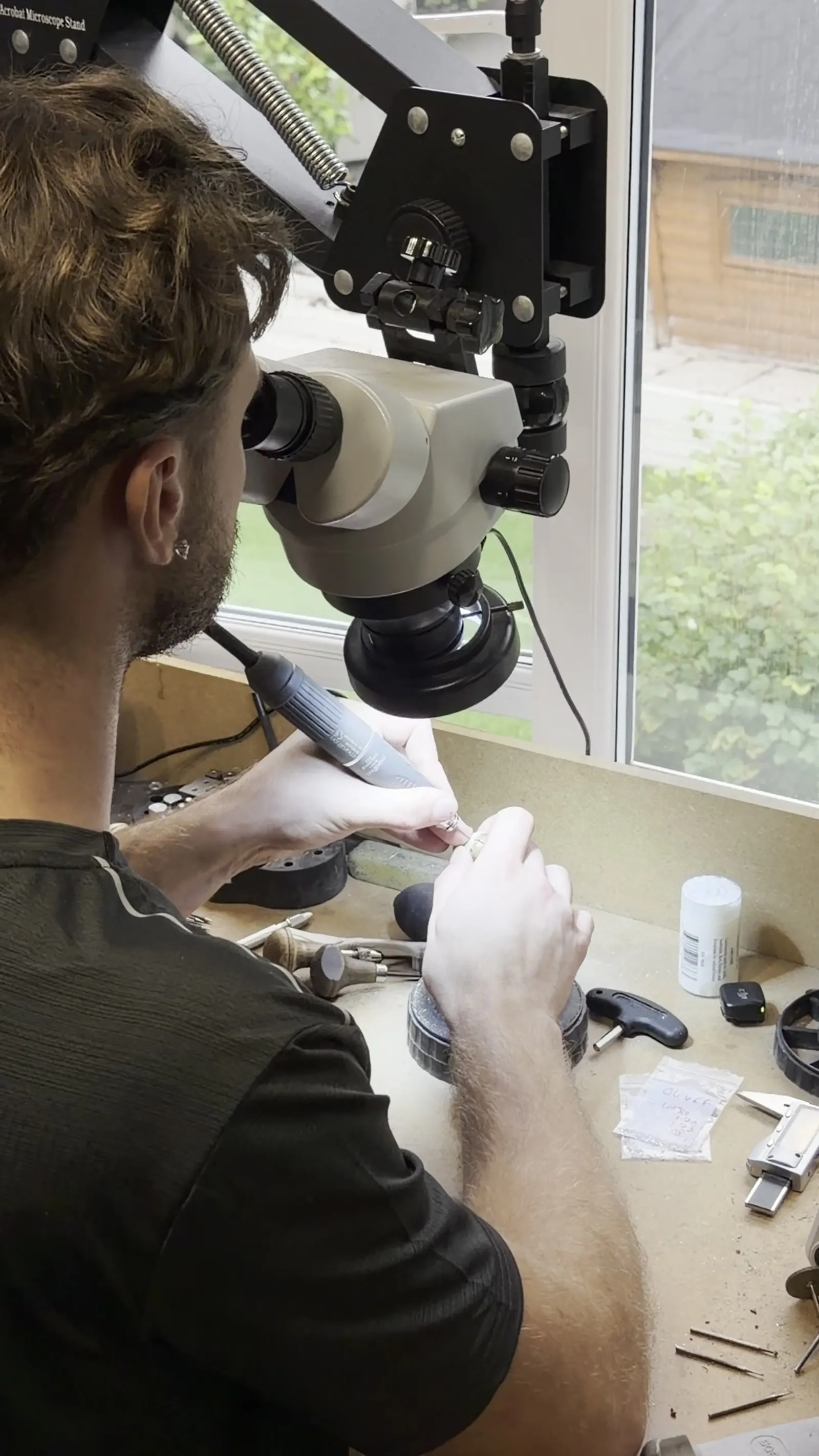 One of the brothers working under a microscope at the bench