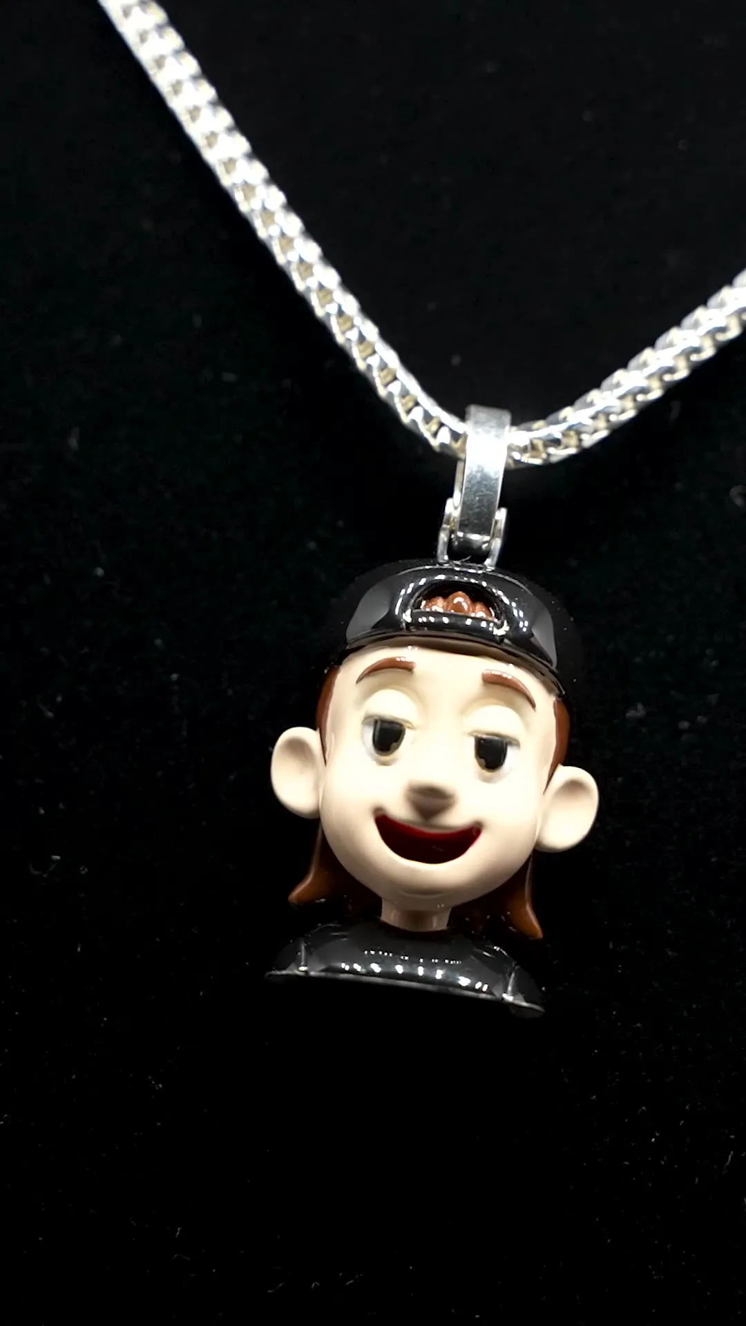 An enamel character pendant on a box chain